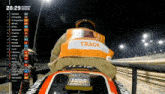 a man wearing a vest that says track is riding a motorcycle