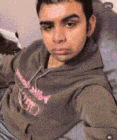 a man wearing a hoodie that says ' supreme ' on the front