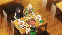 a group of people are sitting at a table with plates of food on it