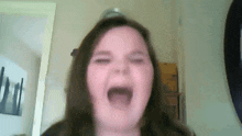 a close up of a girl making a funny face