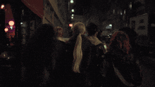 a woman stands in a crowd of people with a tattoo on her back that says ' i love you '