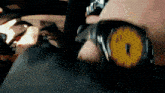 a close up of a person 's face with a watch that has the number 6 on it