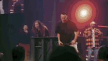 a blurred image of a person playing a guitar