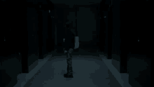 a woman is standing in a dark hallway holding a white bag .