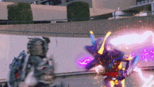 a person is fighting a robot with a purple light coming out of it 's mouth .