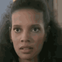 a close up of a woman 's face with a surprised expression .