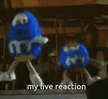 a couple of m & m 's standing next to each other with the words " my live reaction "