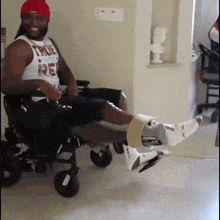 a man in a wheelchair wearing a shirt that says true