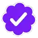a purple cloud with a white check mark in it .