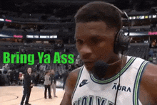 a basketball player wearing headphones and a jersey that says " bring ya ass "