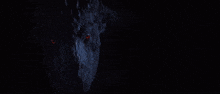 a close up of a person with glowing red eyes