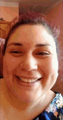 a close up of a woman 's face with a smile