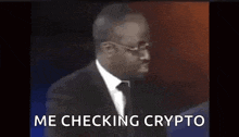 a man in a suit and tie is making a funny face and says me checking crypto .