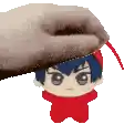 a hand is holding a stuffed toy on top of a stuffed toy .