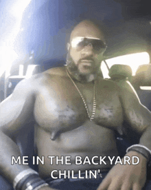 a shirtless man in a car with the words me in the backyard chillin '