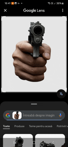 a person holding a gun in their hand on a google lens page