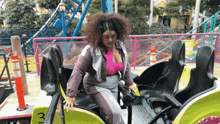 a woman is riding a roller coaster with the number 3 on the side