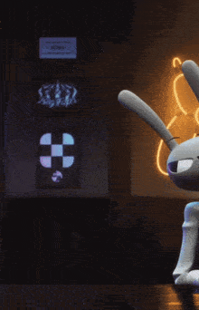 a man in a cowboy hat sits next to a rabbit in front of a neon sign