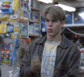 a young man wearing a number 5 shirt stands in front of a toy store