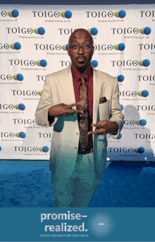 a man stands in front of a toigo foundation wall