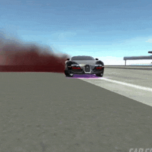 a bugatti is driving down a road with red smoke coming out of the hood