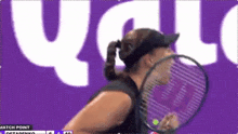 a woman is hitting a tennis ball with a racket .