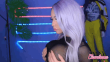 a woman with purple hair has the word clownleen on the bottom of her picture