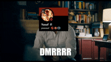 a man sitting in a chair with a picture of yusuf on his head and the word dmrrr on the bottom