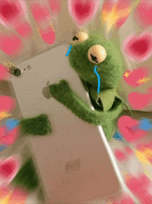 kermit the frog is crying while holding an apple iphone