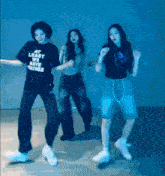 a girl wearing a shirt that says at least you have yourself is dancing with two other girls