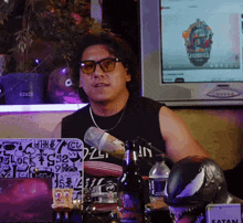 a man sitting at a table with a sign that says " satan "