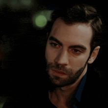 a man in a suit and tie is making a face