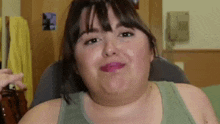 a woman with a very large neck is making a funny face while sitting in a chair .