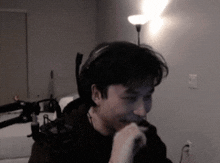 a man wearing headphones looks at the camera in a dark room