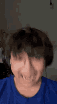 a close up of a person making a funny face while wearing headphones .