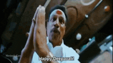 a man in a white shirt is saying happy deepavali