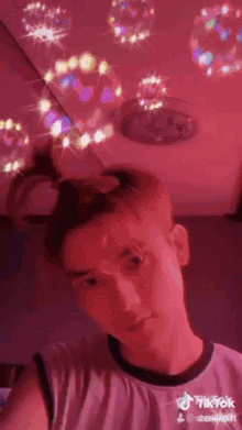 a young man is taking a selfie with bubbles in the background