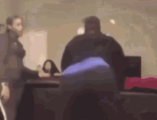 a blurry picture of a man and a woman standing next to each other .