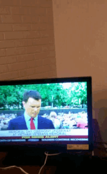 a man in a suit and tie is on a tv screen