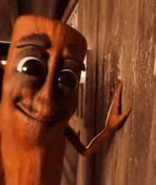 a close up of a wooden stick with a face and arms .