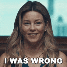 a woman is smiling with the words i was wrong behind her