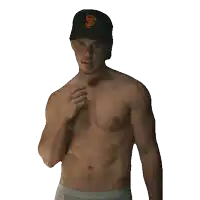a shirtless man is wearing a san francisco giants baseball cap