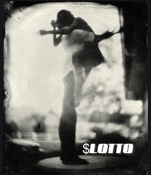 a black and white photo of a man carrying a woman with the word lotto on the bottom right