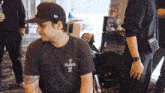 a man wearing a black t-shirt that says i dog on it
