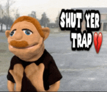 a puppet is standing in front of a sign that reads " shut yer trap "