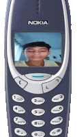 a nokia phone with a picture of a young man on the screen