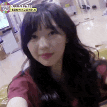 a girl is taking a selfie in front of a tv screen that says go