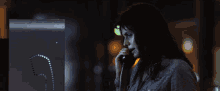 a woman is talking on a phone with the letter s on the side