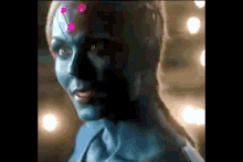 a close up of a woman 's face with blue paint on it