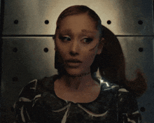 a woman with a tattoo on her neck that says ' ariana grande ' on it